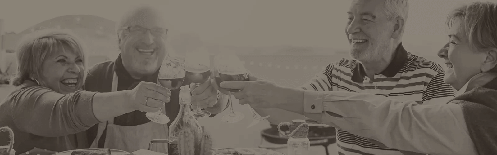 friends cheers-ing their drinks over a meal